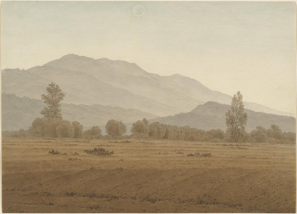 Caspar David Friedrich: a misty, empty plain with a few trees and soft blue mountains under a pale sky.